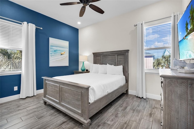 bedroom featuring light hardwood / wood-style floors and ceiling fan