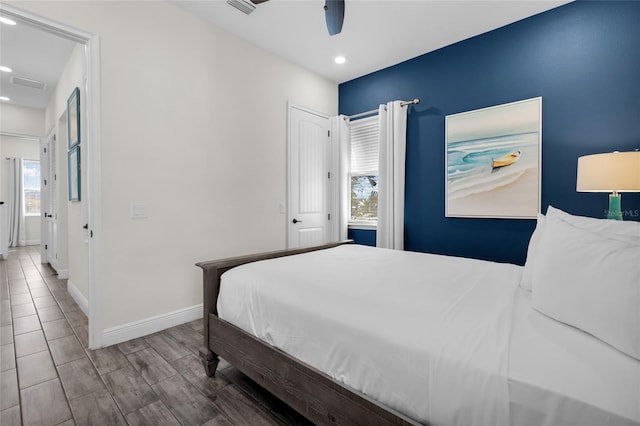 bedroom with ceiling fan and hardwood / wood-style flooring