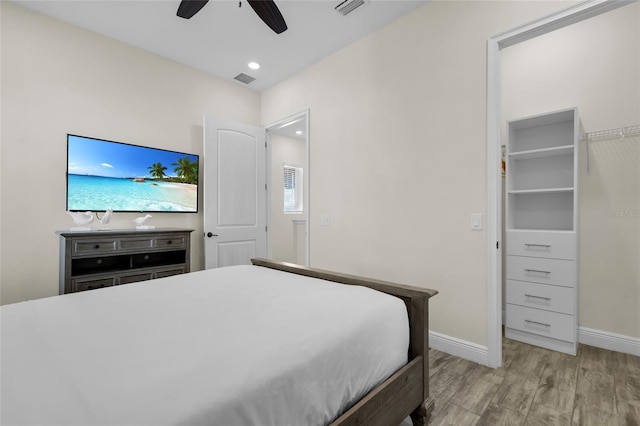 bedroom with light hardwood / wood-style floors and ceiling fan