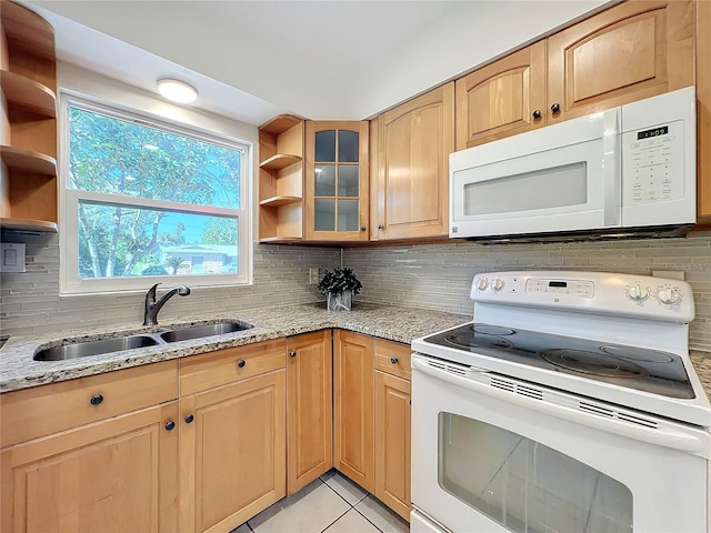 kitchen featuring decorative backsplash, white appliances, sink, and light tile patterned floors