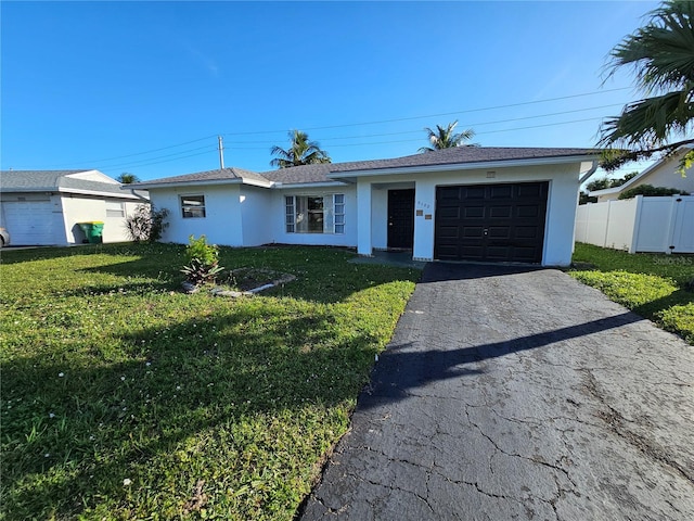 single story home with a front lawn and a garage