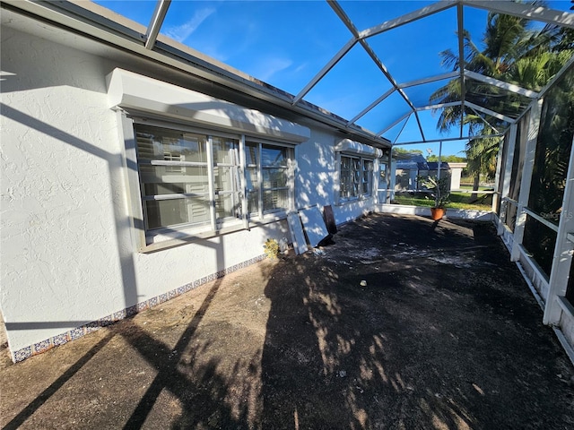 view of side of property featuring glass enclosure