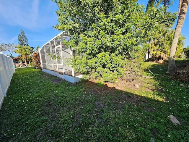 view of yard featuring glass enclosure