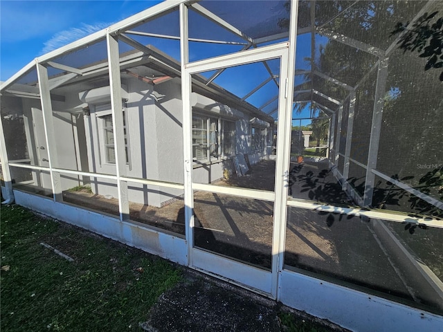 view of side of home with a lanai