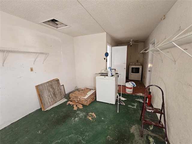 basement featuring ceiling fan, a textured ceiling, and washer / dryer