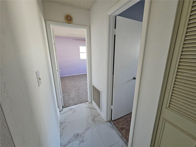 hallway featuring light colored carpet