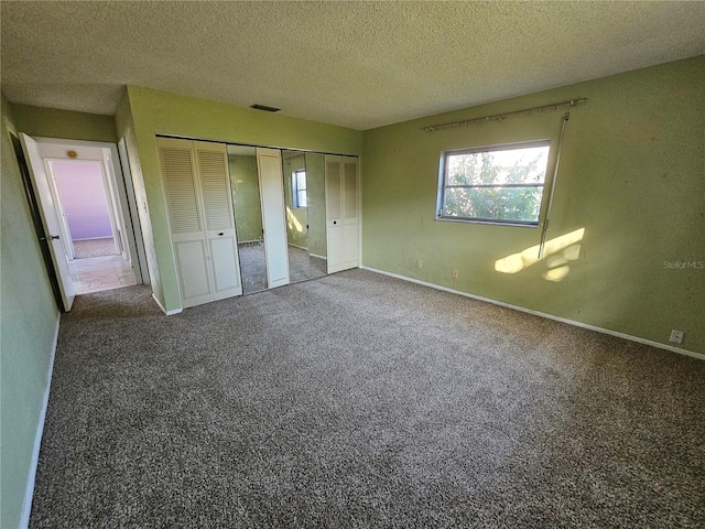 unfurnished bedroom featuring carpet and a textured ceiling