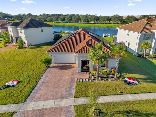 view of front of house with a water view, a front yard, and a garage