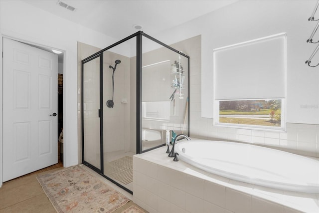 1651 Kingfisher Ct, Kissimmee, FL 34746 - full bath featuring a stall shower, a garden tub, and tile patterned floors