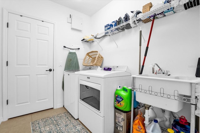 1651 Kingfisher Ct, Kissimmee, FL 34746 - washroom featuring washer and clothes dryer and light tile patterned floors
