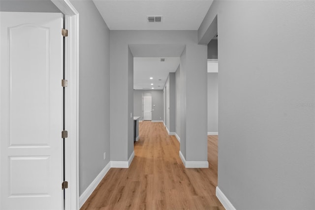 corridor with light wood-type flooring