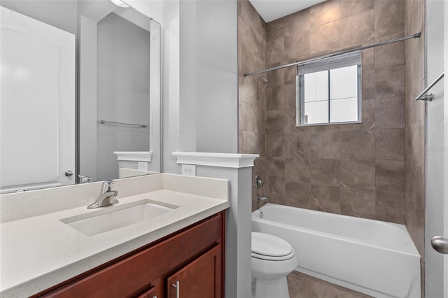 full bathroom featuring tile patterned flooring, vanity, toilet, and tiled shower / bath