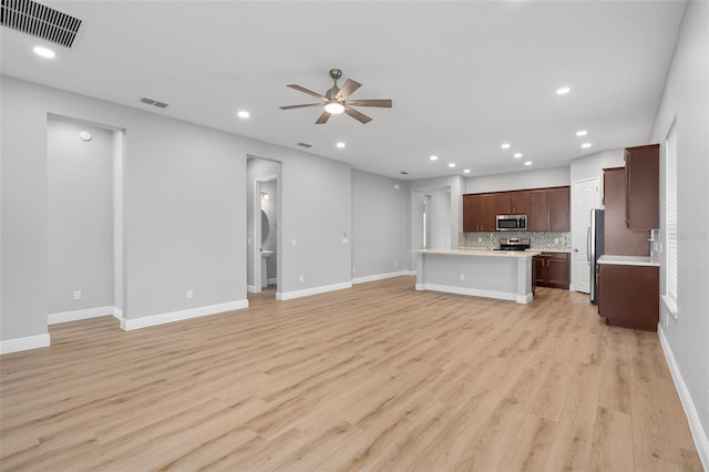 unfurnished living room with ceiling fan and light wood-type flooring