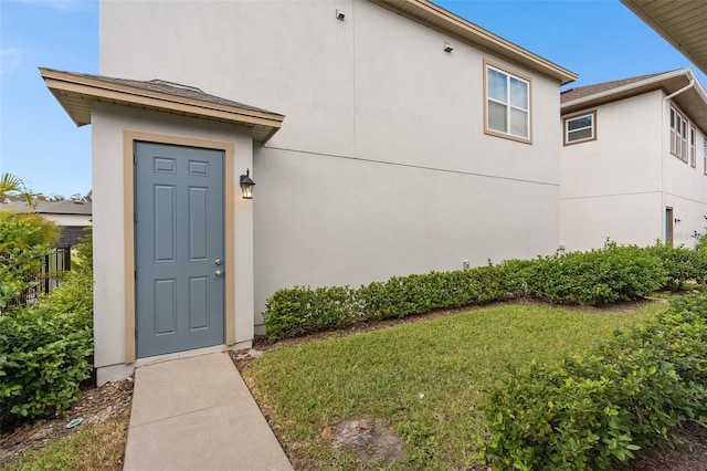 doorway to property featuring a yard