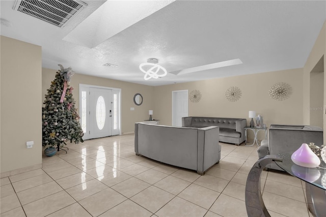 tiled living room featuring a textured ceiling