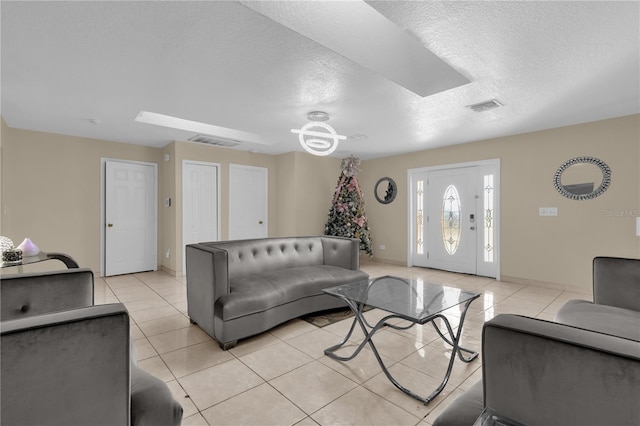 living room with light tile patterned floors and a textured ceiling