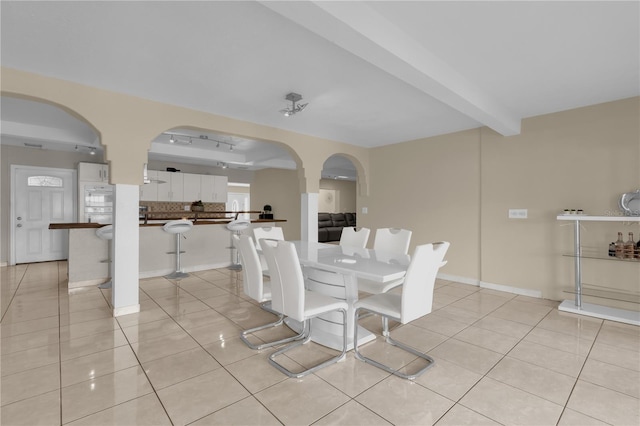 tiled dining space with beam ceiling