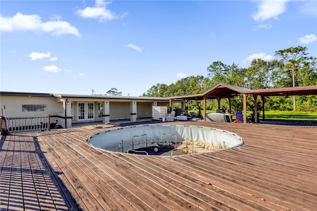 view of pool with a wooden deck and french doors