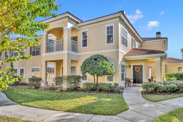 mediterranean / spanish-style home featuring a front lawn