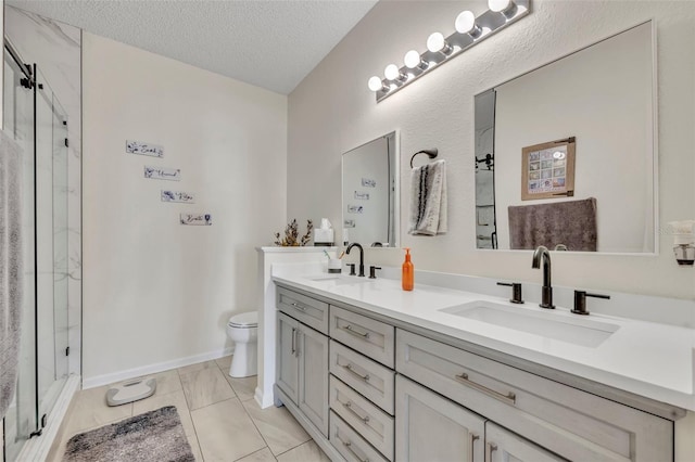 bathroom with tile patterned floors, a textured ceiling, toilet, a shower with door, and vanity