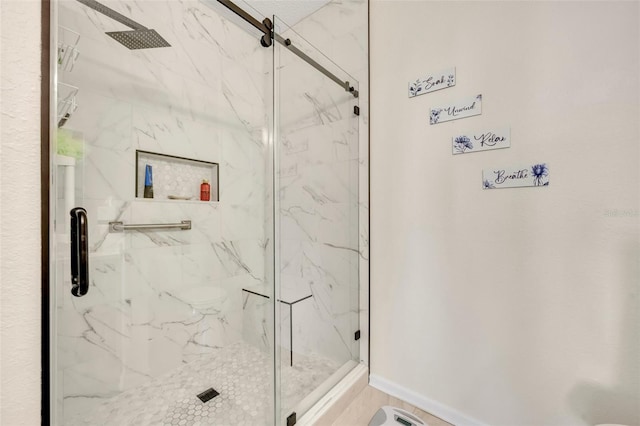 bathroom featuring a shower with shower door