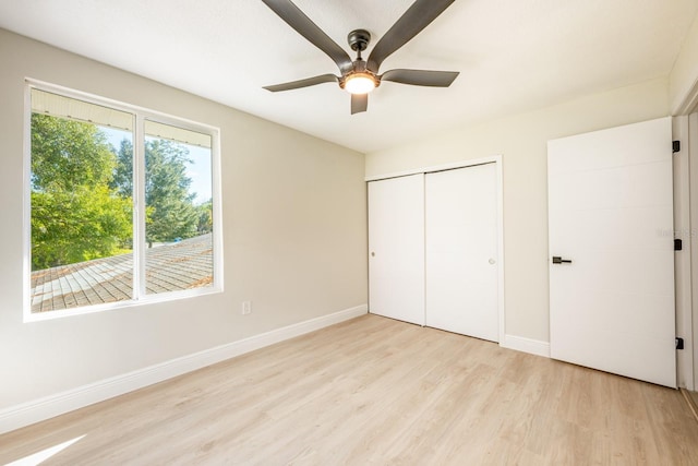 unfurnished bedroom featuring ceiling fan, a closet, and light hardwood / wood-style floors