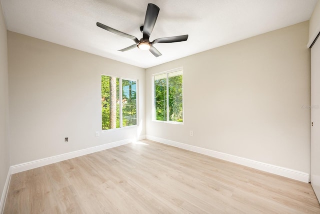 empty room featuring ceiling fan, a textured ceiling, and light hardwood / wood-style flooring