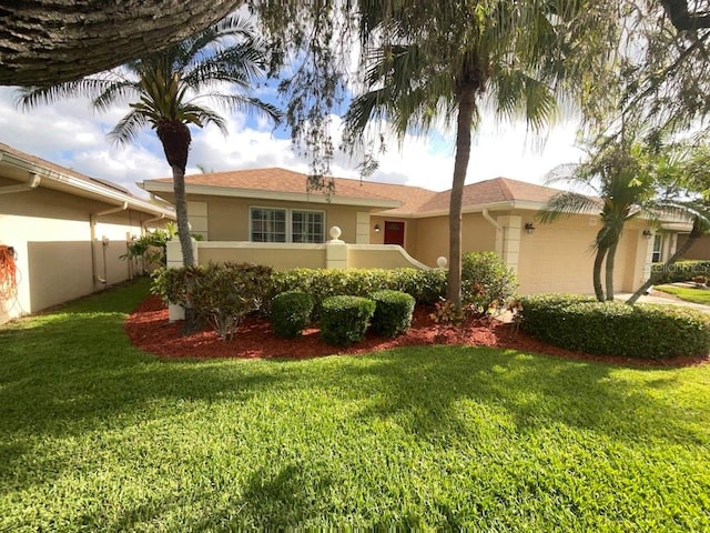 view of front of property with a garage and a front lawn