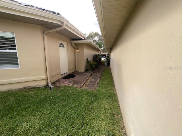 view of side of property with a yard