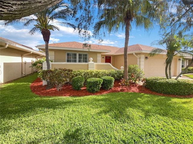 view of front facade with a front yard and a garage