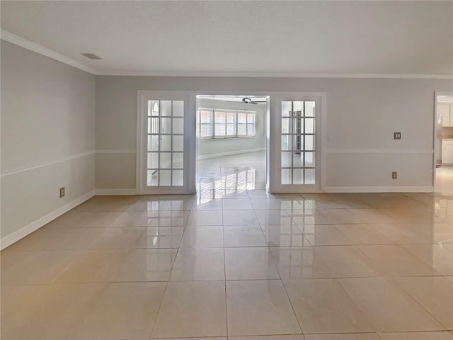 empty room with crown molding, light tile patterned floors, and ceiling fan