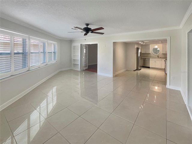 spare room featuring a textured ceiling, ceiling fan, ornamental molding, and light tile patterned flooring