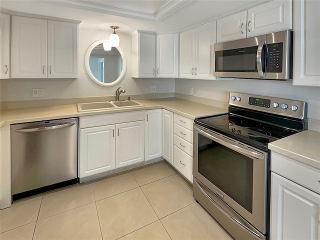 kitchen with white cabinetry, sink, appliances with stainless steel finishes, and ornamental molding