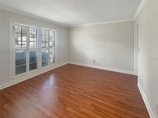 empty room with dark hardwood / wood-style flooring, a textured ceiling, and ornamental molding