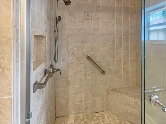 bathroom with a tile shower