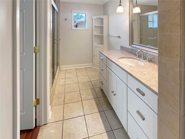 bathroom with vanity, tile patterned floors, and a shower with shower door