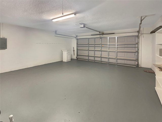 garage featuring a garage door opener and electric panel