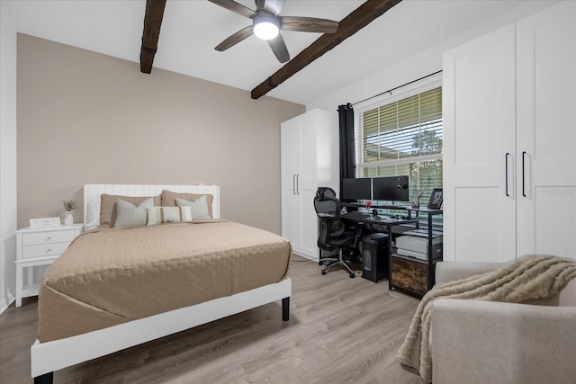 bedroom featuring beam ceiling, light hardwood / wood-style floors, and ceiling fan