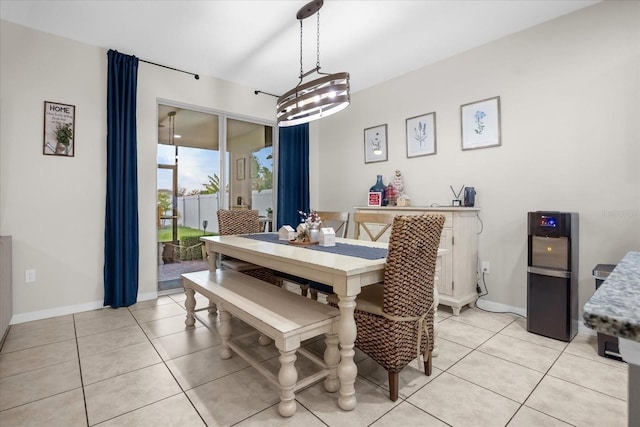 dining space with light tile patterned floors and a notable chandelier