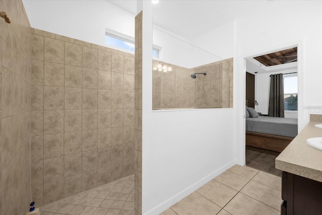 bathroom with hardwood / wood-style flooring, vanity, and tiled shower