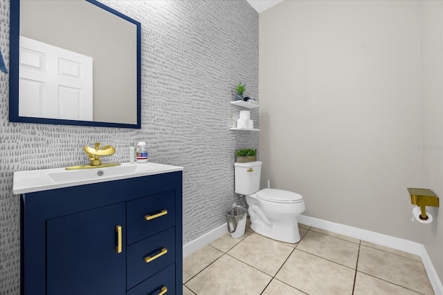 bathroom featuring toilet, vanity, and tile patterned floors