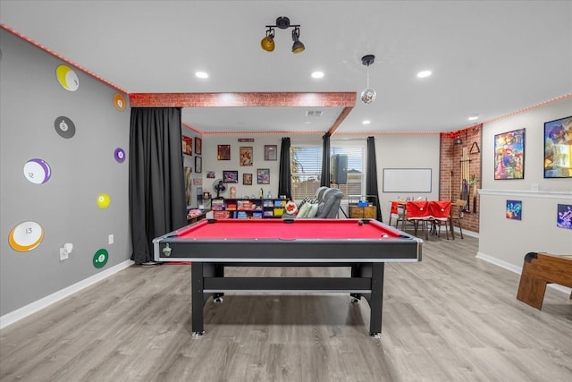 rec room with brick wall, billiards, and light hardwood / wood-style flooring