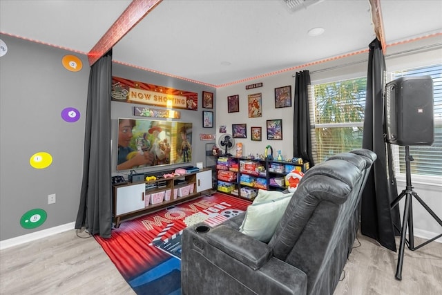 game room with wood-type flooring and ornamental molding