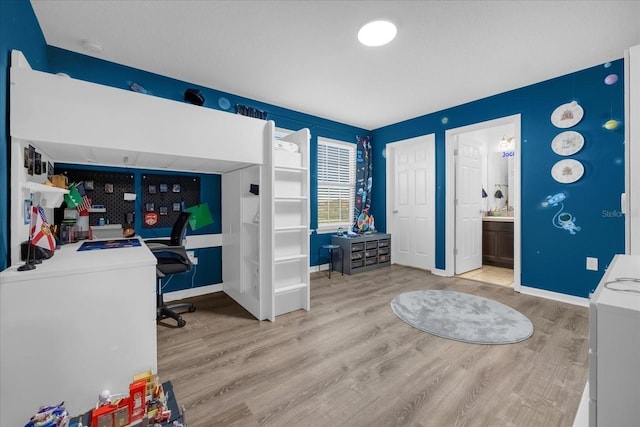 interior space featuring ensuite bathroom and light hardwood / wood-style floors