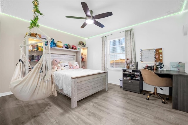 bedroom featuring ceiling fan and light hardwood / wood-style floors