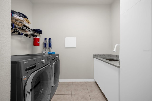 clothes washing area featuring independent washer and dryer, sink, and light tile patterned floors