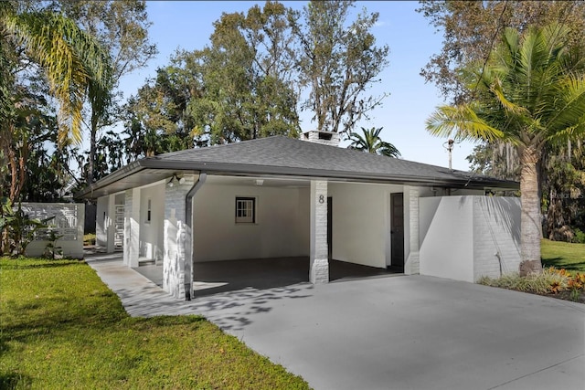 exterior space with a front lawn and a carport