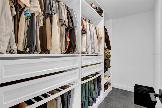 spacious closet with dark tile patterned flooring