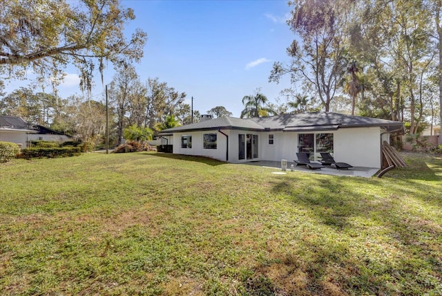 back of property featuring a yard and a patio