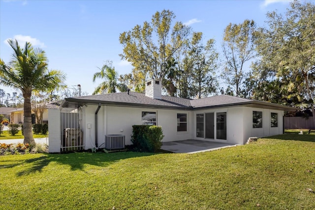 rear view of property with a yard, a patio area, and central air condition unit